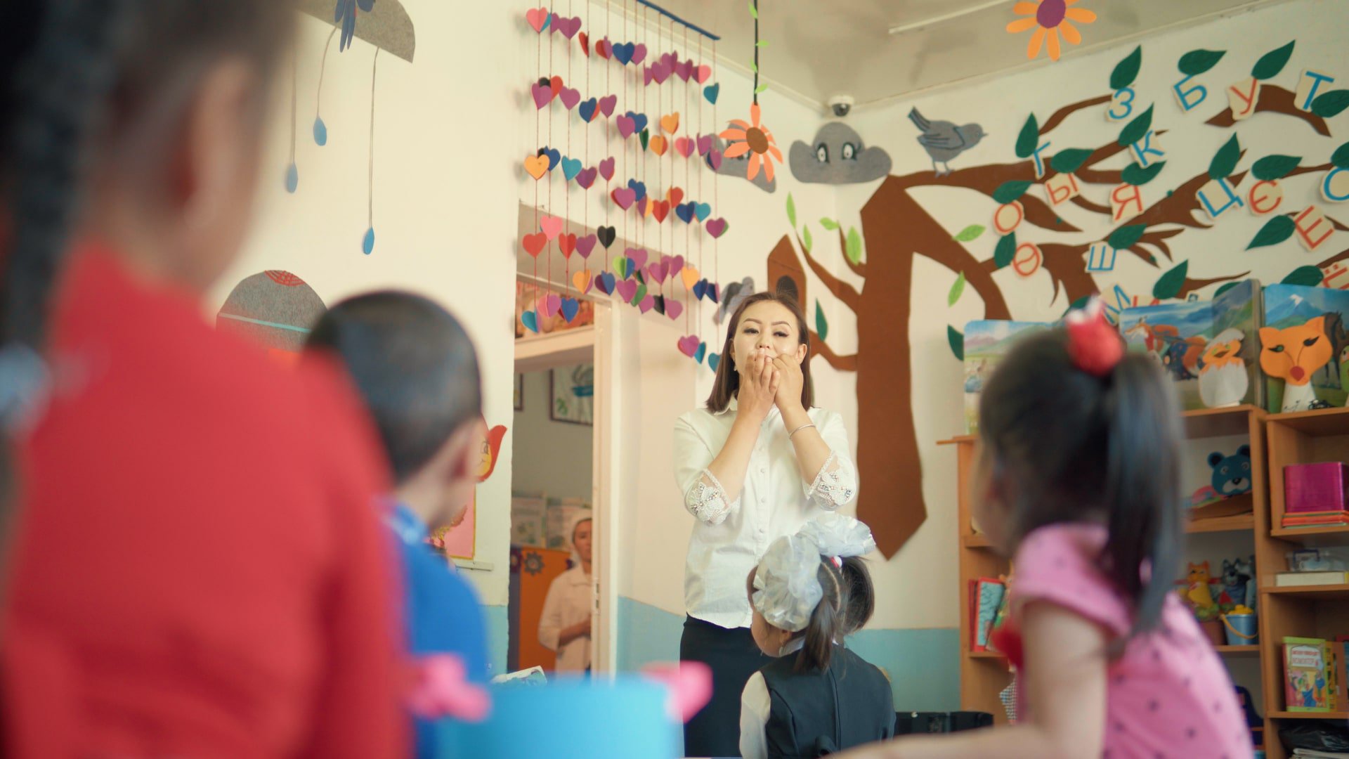 Photo of Gulbarak in the classroom teaching children.